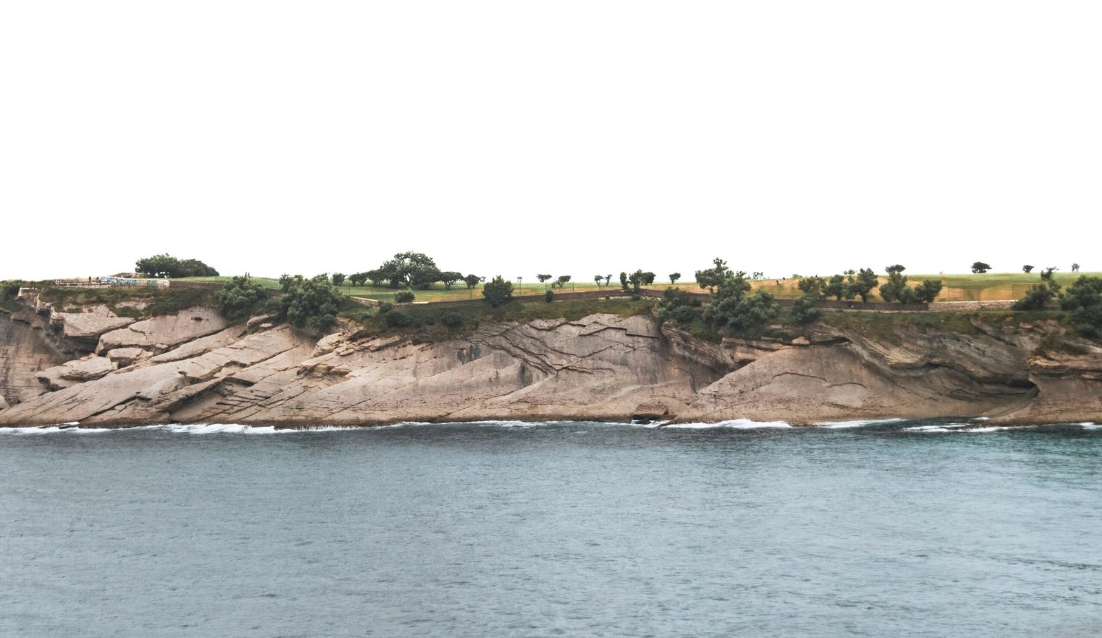 a large body of water next to a cliff